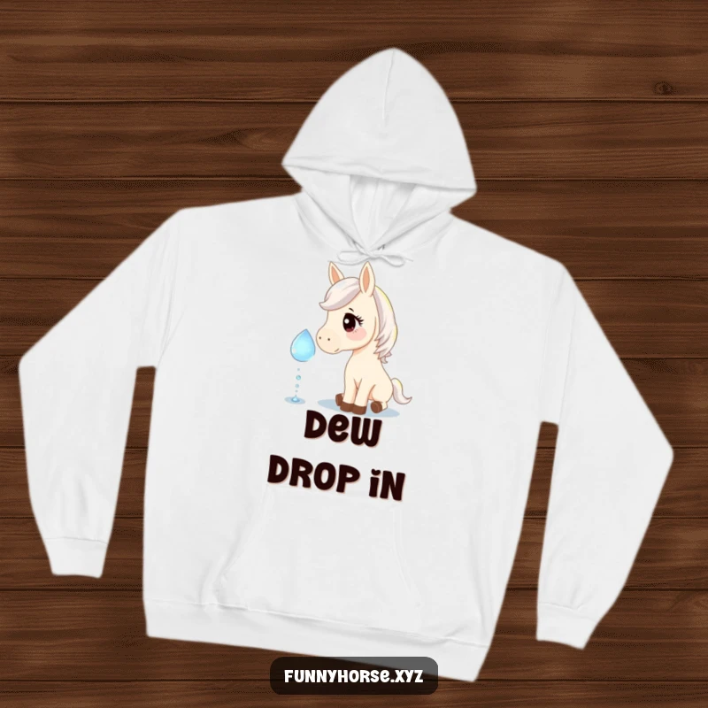 Funny hoodie showing a curious horse gently nudging a giant, sparkling dewdrop, offering warmth and a touch of whimsical humor.