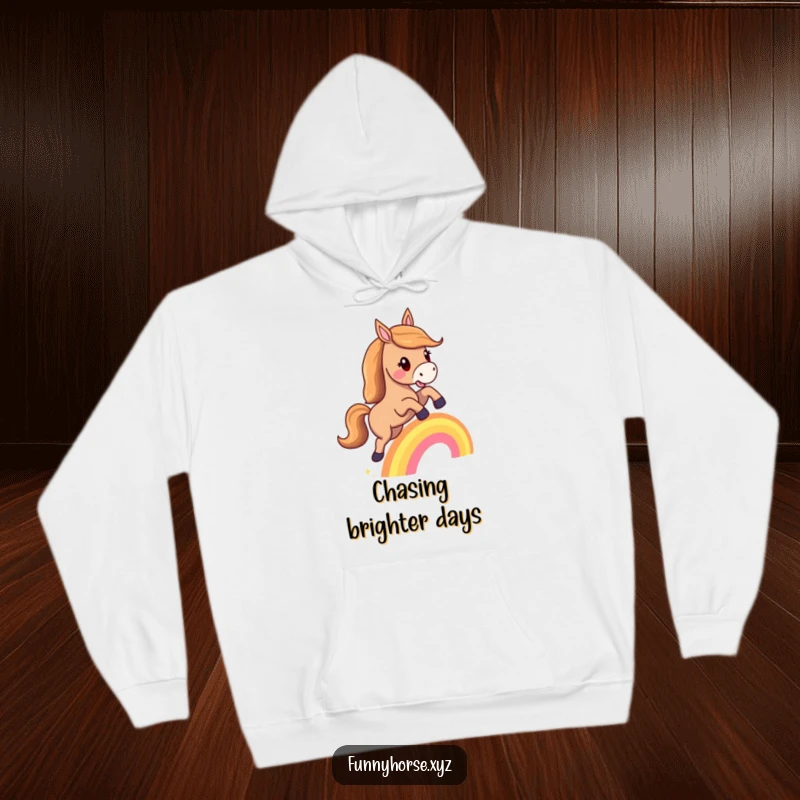 Funny hoodie: A happy horse with a flowing mane joyfully leaps over a tiny rainbow, radiating magical charm.